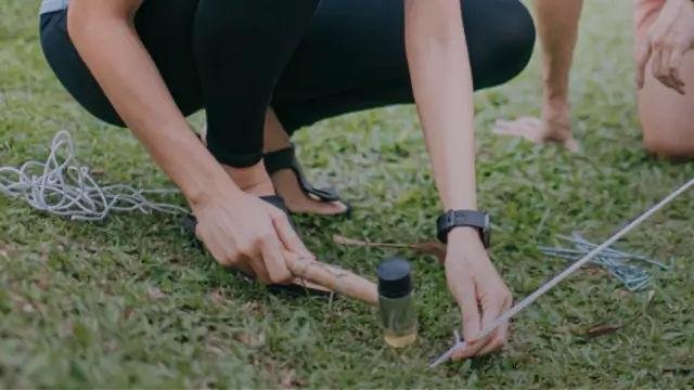 A couple setting up tent camping using mallet